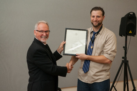 Nick Wilson, Undergraduate Architecture, receives the Henry Adams Medal from Len Zegarski, Chair, Undergraduate
