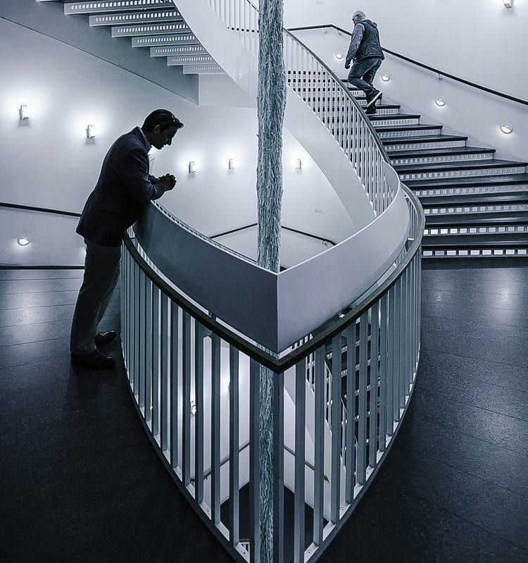 an architecture professional looking down at a flight of stairs