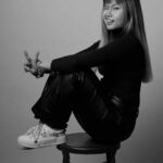 A picture of Uyen smiling on a chair