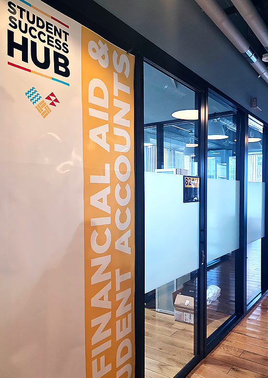 door of the financial aid office. It has a yellow vertical band and the text reads: financial aid & students accounts